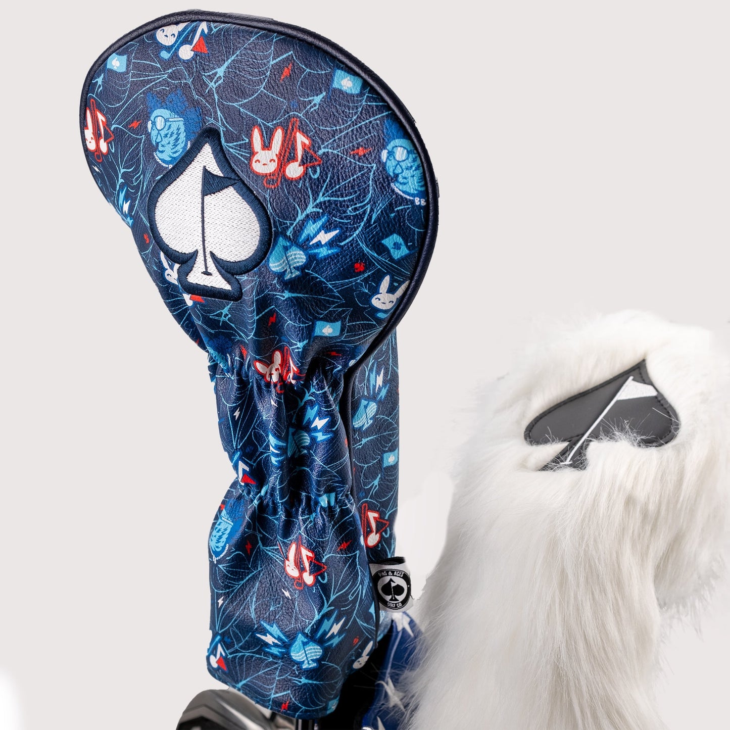 Good Bunny X Fundación Rimas driver cover featuring a vibrant design and embroidered branding, ideal for golf enthusiasts.