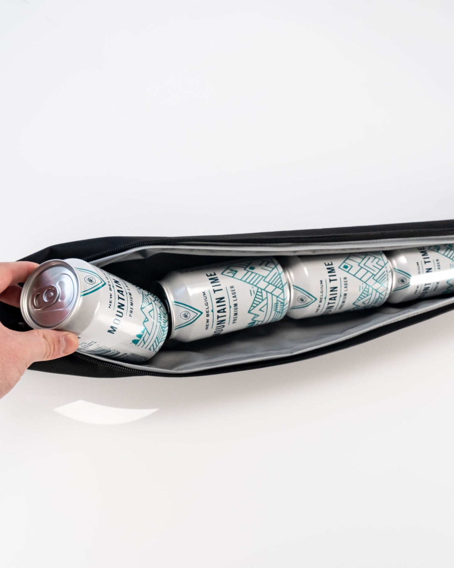 Golfers gift pack with four Mountain Time beer cans in an olive green color, stored in a black carrying case.