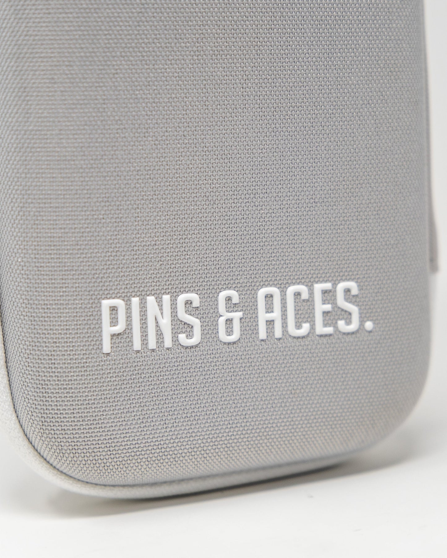Gray glove and accessory caddie featuring the Pins & Aces logo, designed for organized storage and easy access.