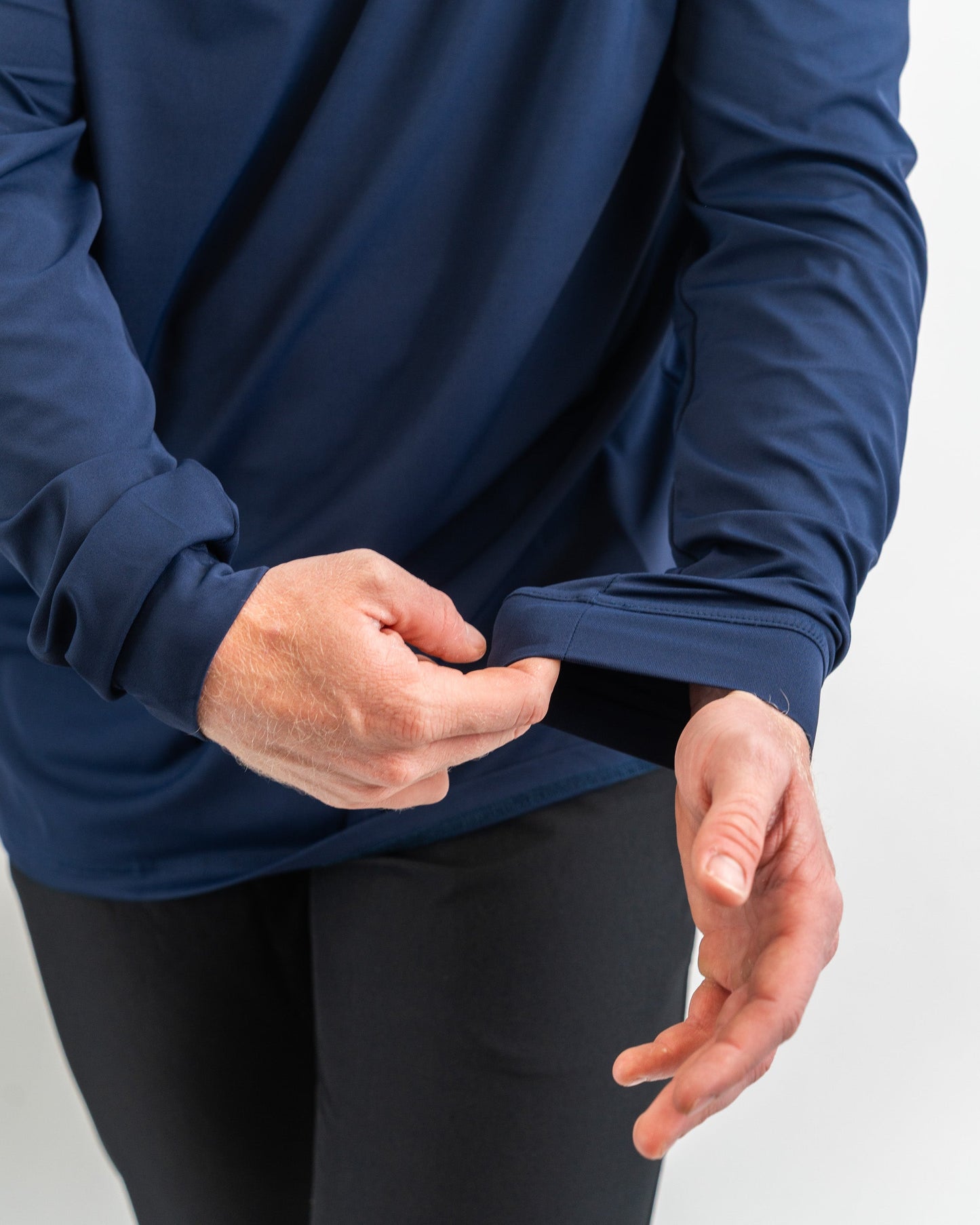 Navy performance golf hoodie featuring a comfortable fit and thumbhole cuffs for enhanced coverage during play.