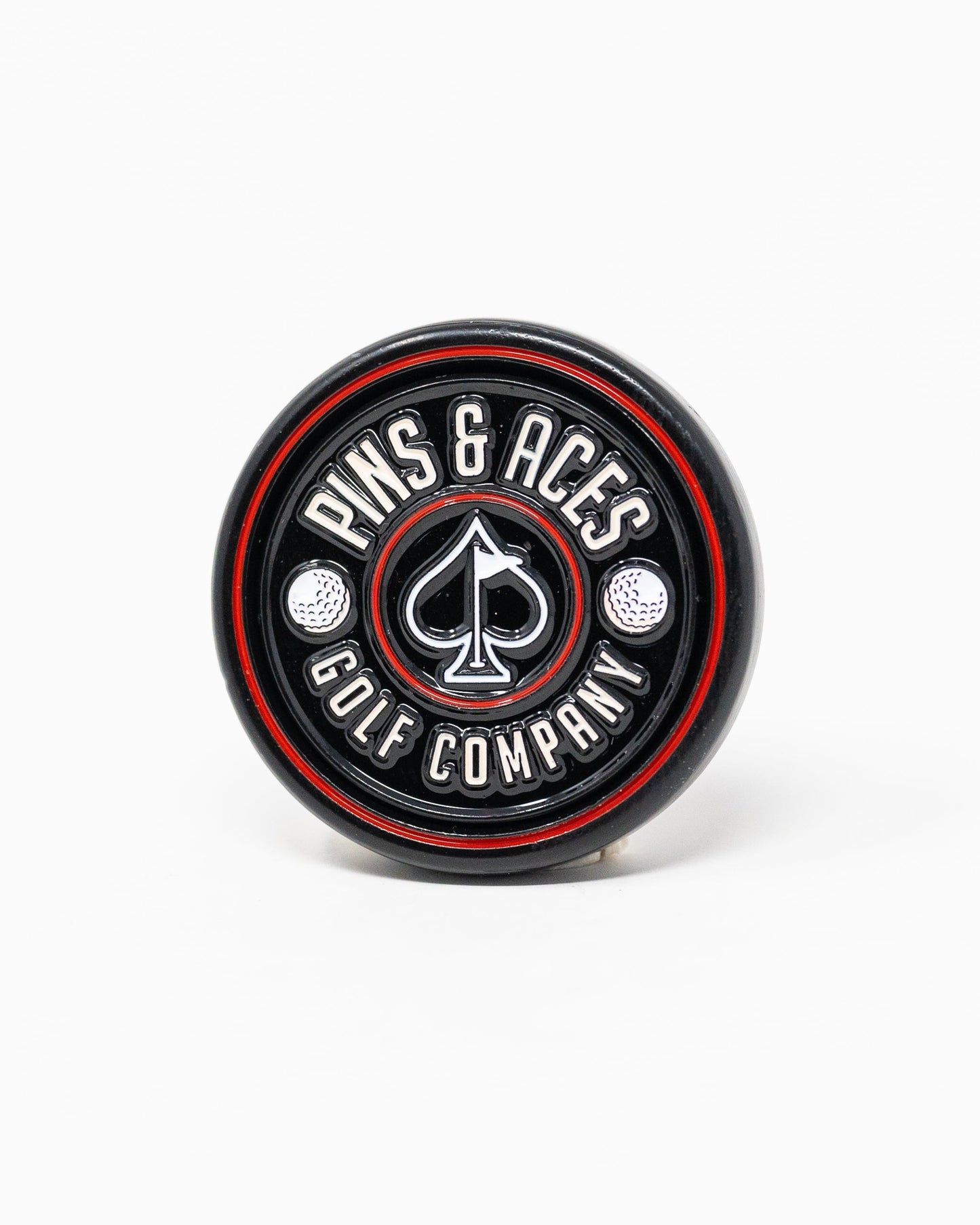 Black Pop Out Medallion Ball Marker, showcasing a sleek design and compact size for easy use on the golf course.