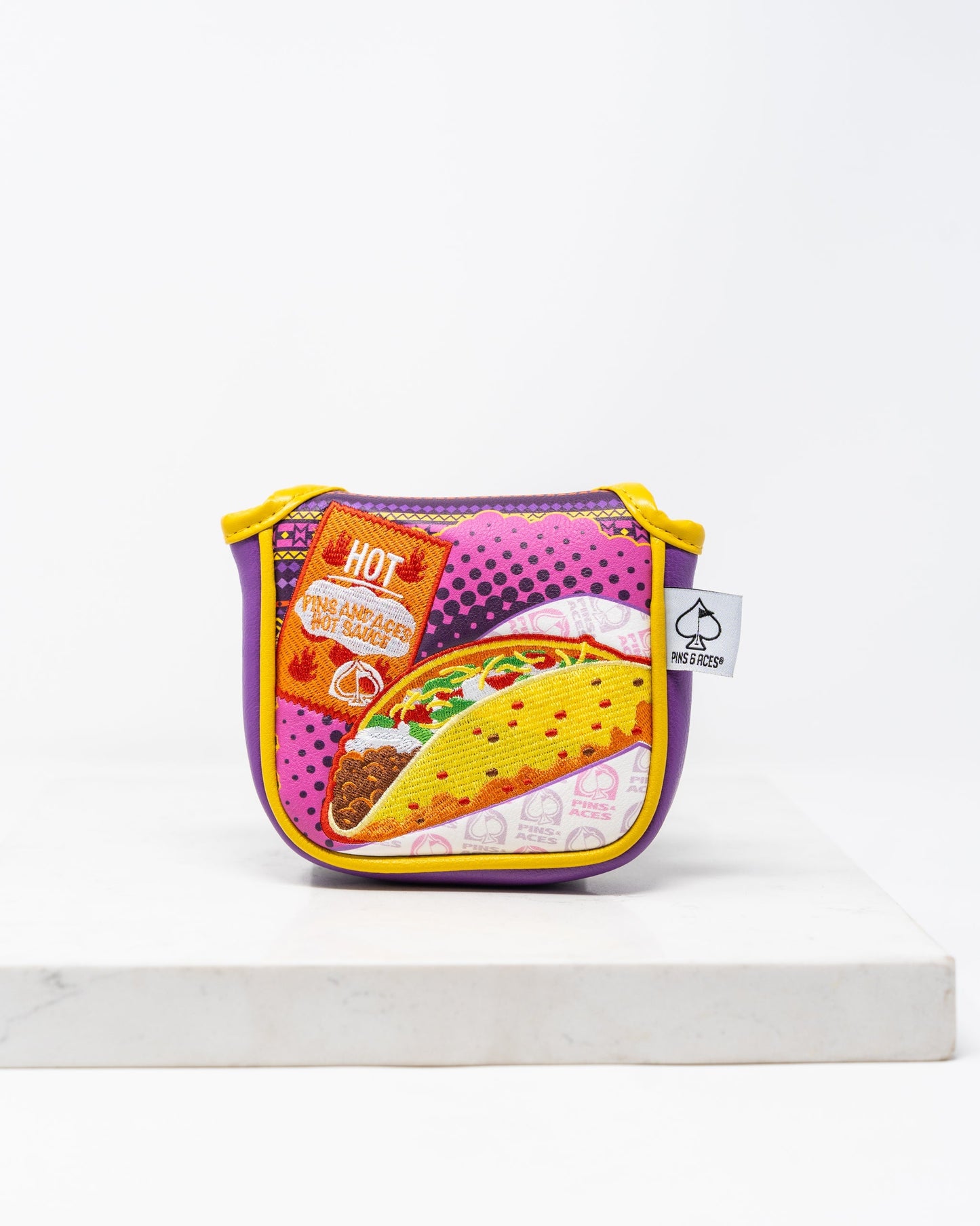 Alt text: "The Bogey Supreme mallet putter cover in vibrant colors with a sleek design featuring a logo, designed for improved protection and style on the golf course."