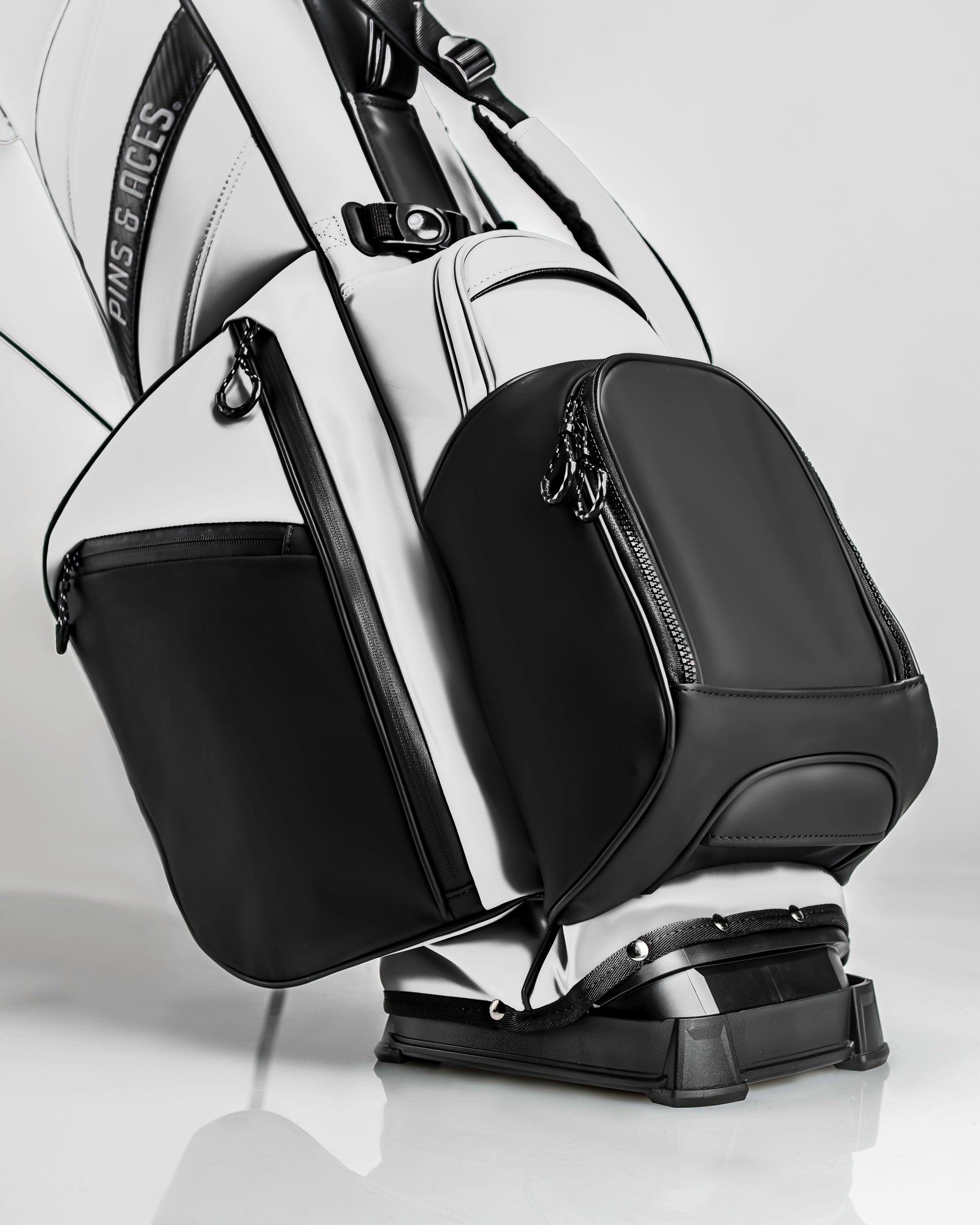 Stylish Player Preferred Golf Bag in white and black, featuring sleek design and multiple zippered pockets for storage.