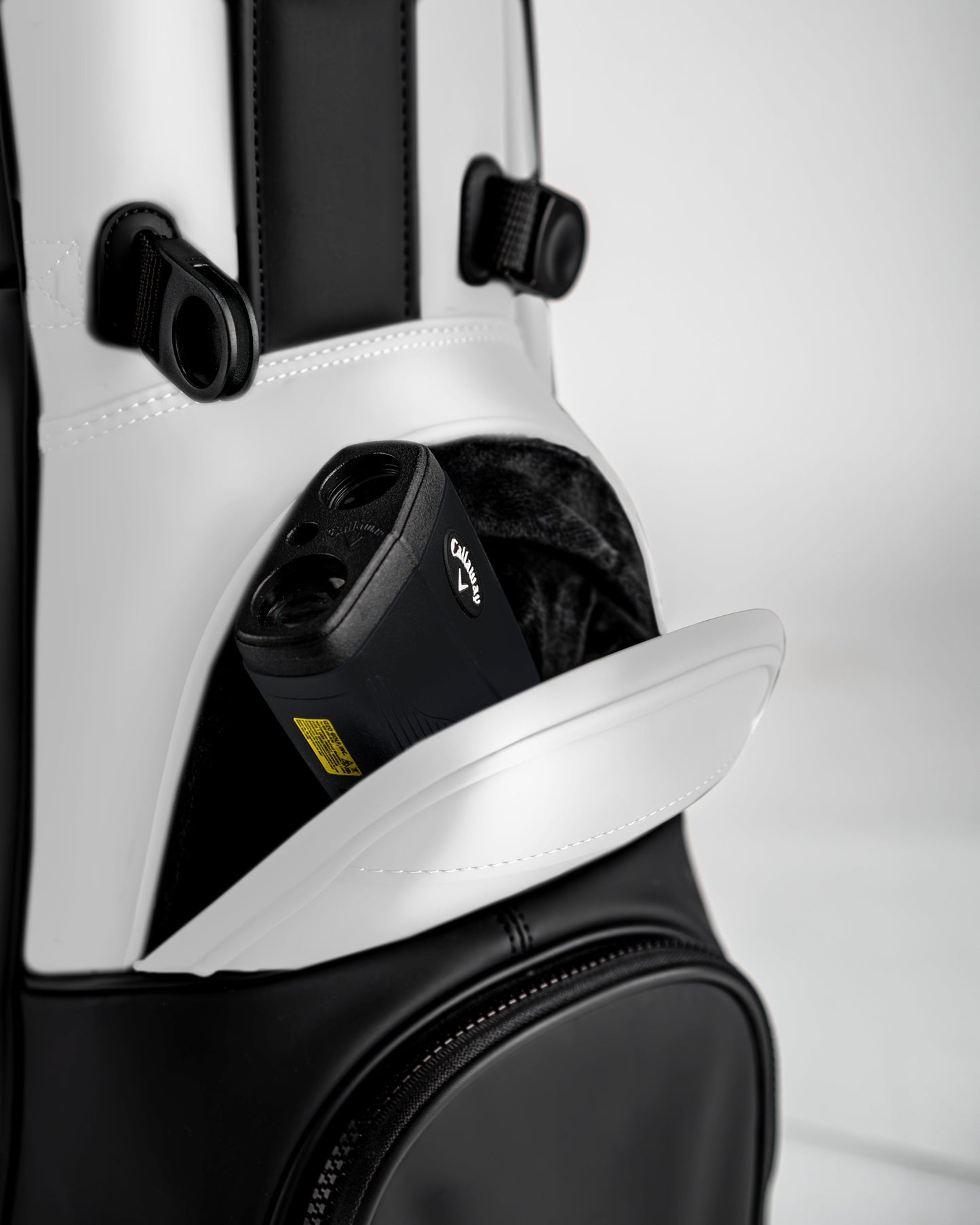 Close-up of the Player Preferred Golf Bag in Domino design, featuring a pocket with a golf rangefinder inside.