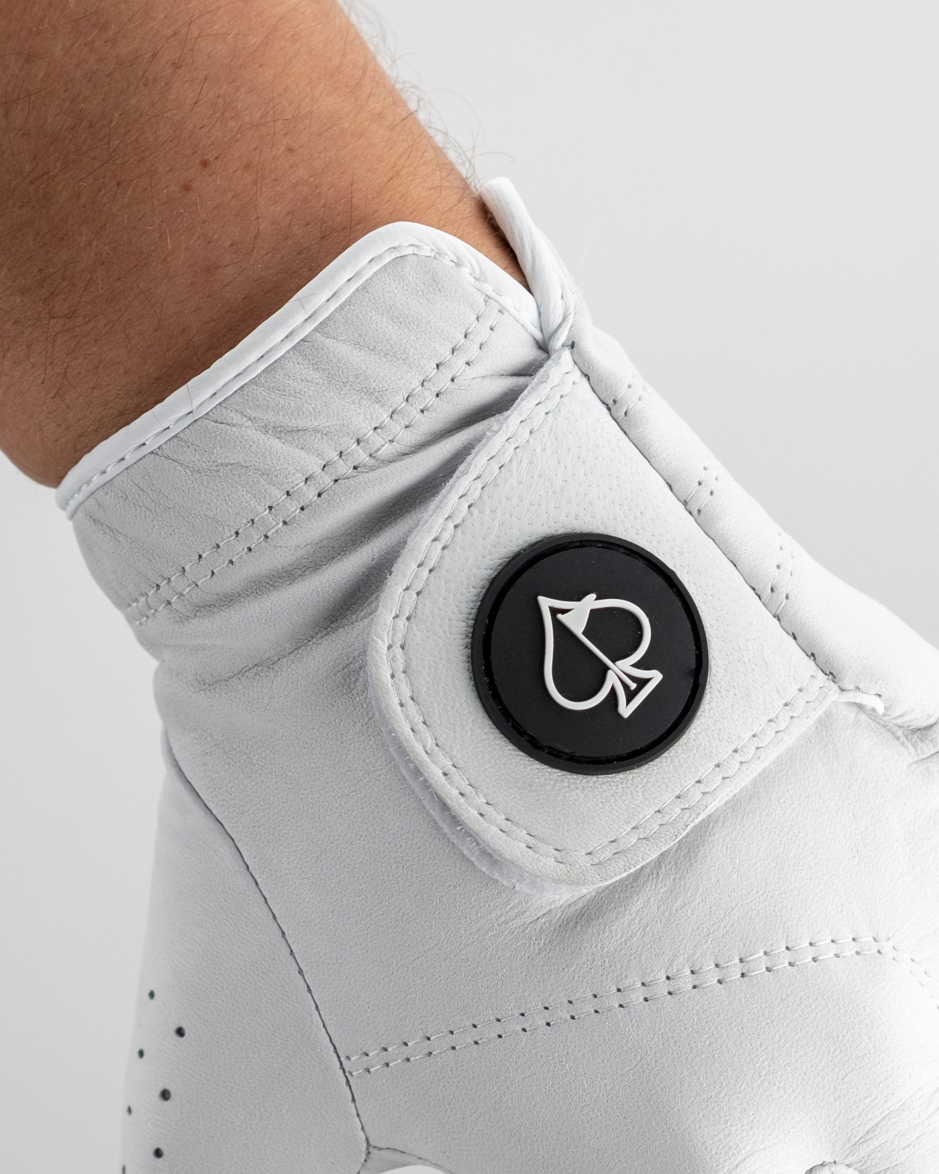 Premium Tour Glove in Ghost White featuring a sleek design and a logo button on the wrist for a stylish golf accessory.