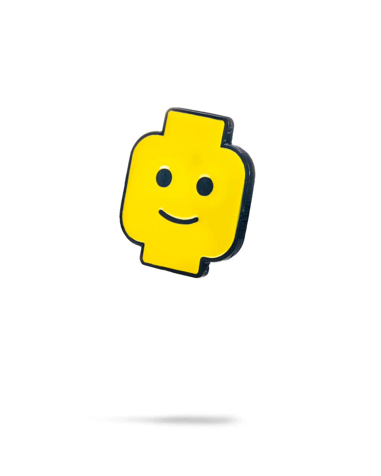 Bright yellow Block Head ball marker featuring a smiling face, perfect for adding fun to your golf game.