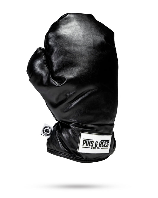 Black boxing glove driver cover, designed for golf club protection with a sleek and sporty appearance.