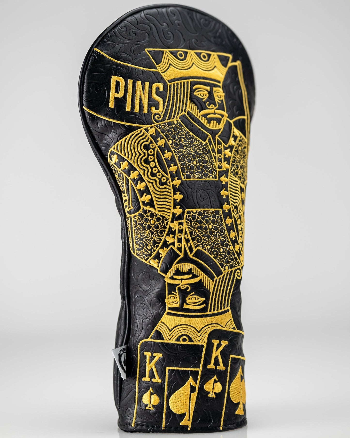 Black and gold King of Spades driver cover with intricate design, featuring a spade emblem prominently displayed.