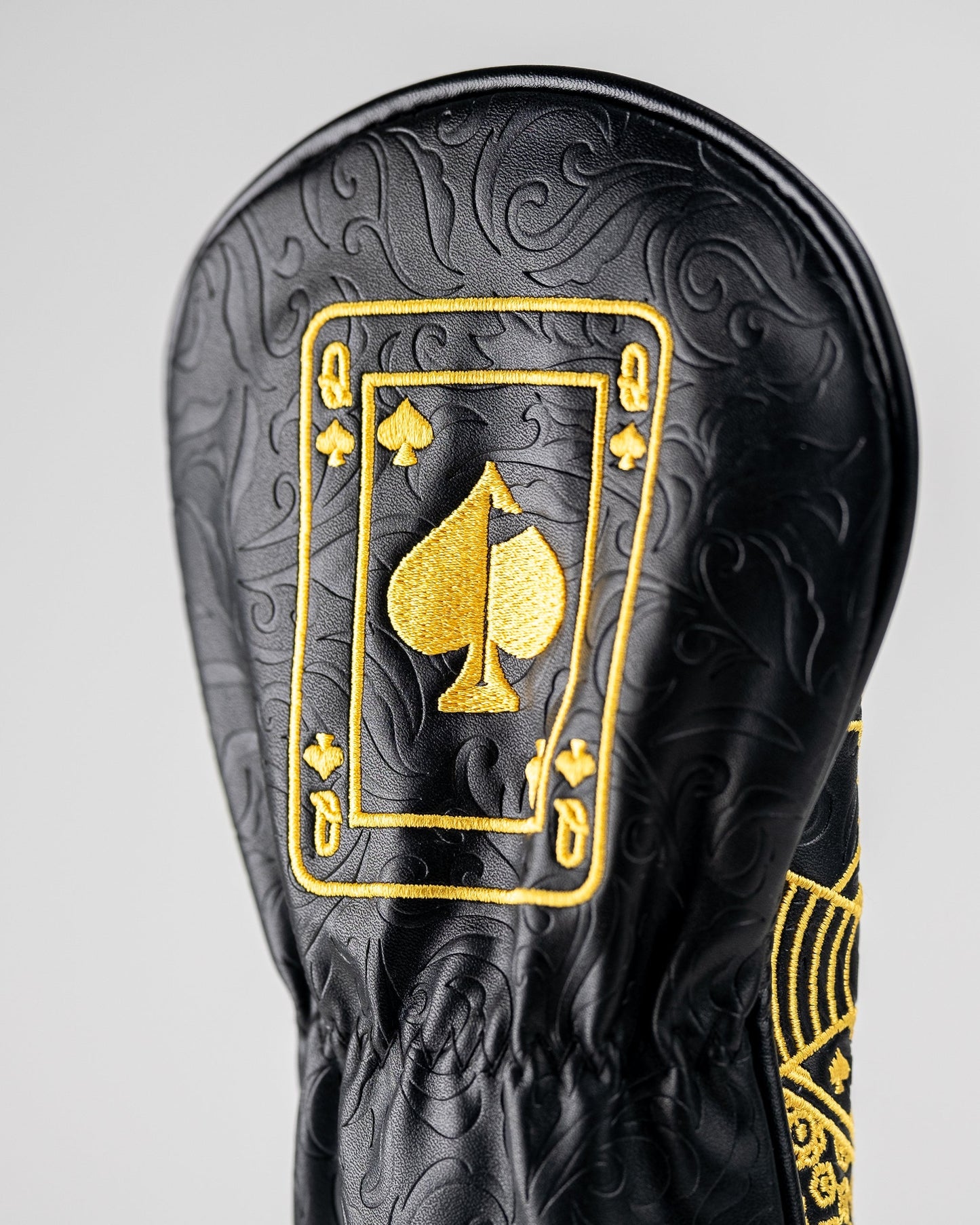 Black and gold Queen of Spades fairway cover with a sleek design and embroidered card symbol.