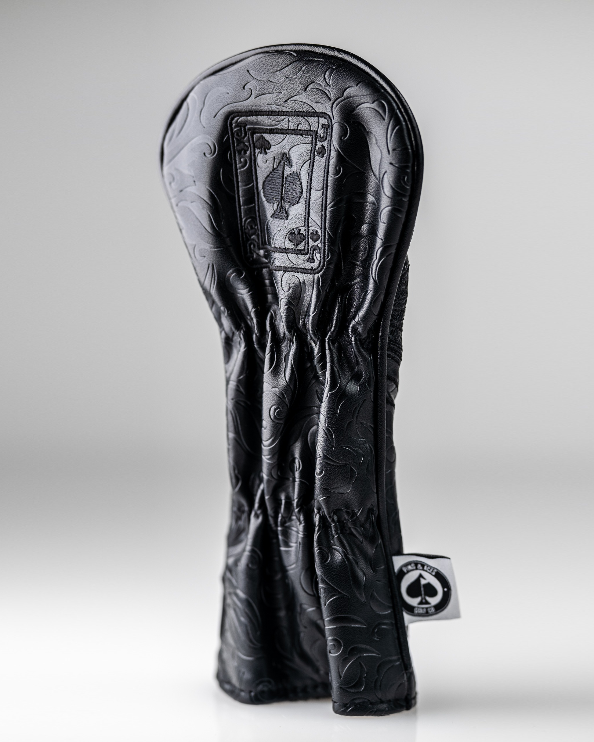 Blackout Jack of Spades hybrid golf club cover with embossed design, featuring a spade symbol and sleek black finish.
