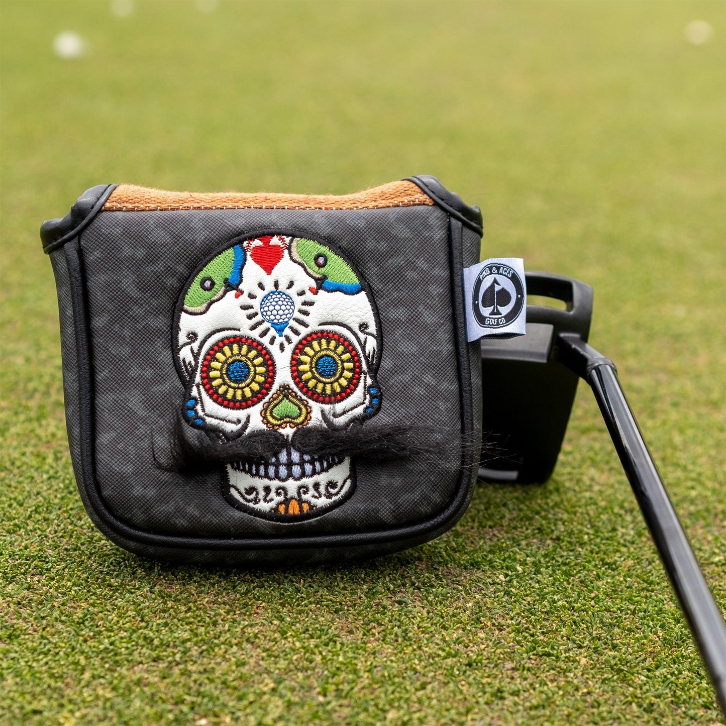 Gray camo mallet putter cover featuring a mustache sugar skull design.