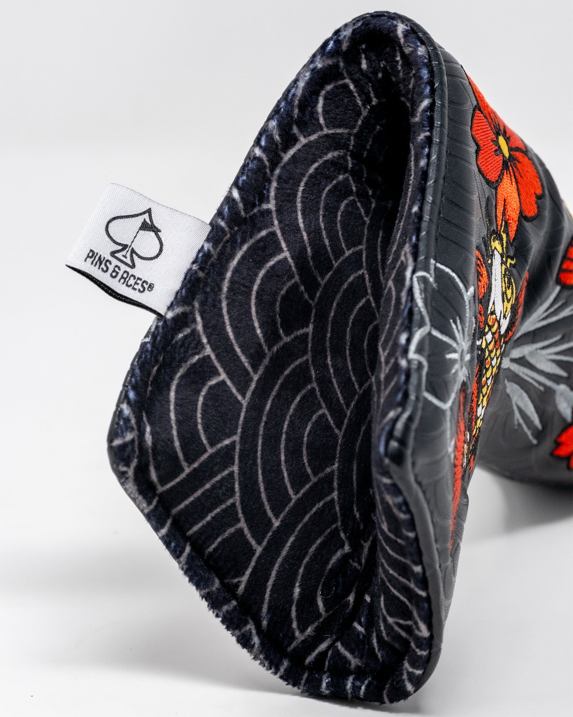 Koi Flow Blade Putter Cover featuring vibrant fire waves design on a black background.