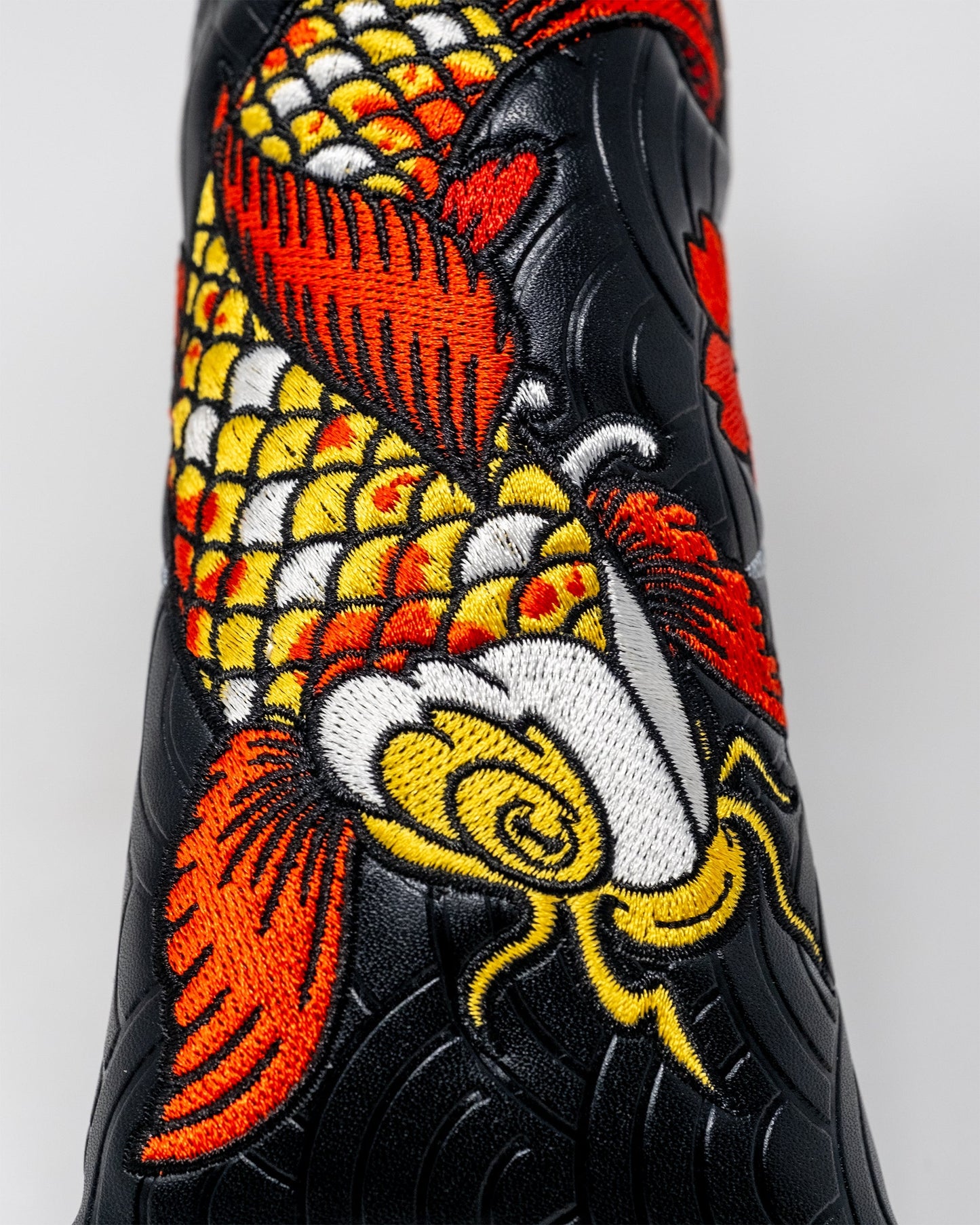 Koi Flow Blade Putter Cover featuring a vibrant fire waves design, crafted for protection and style.