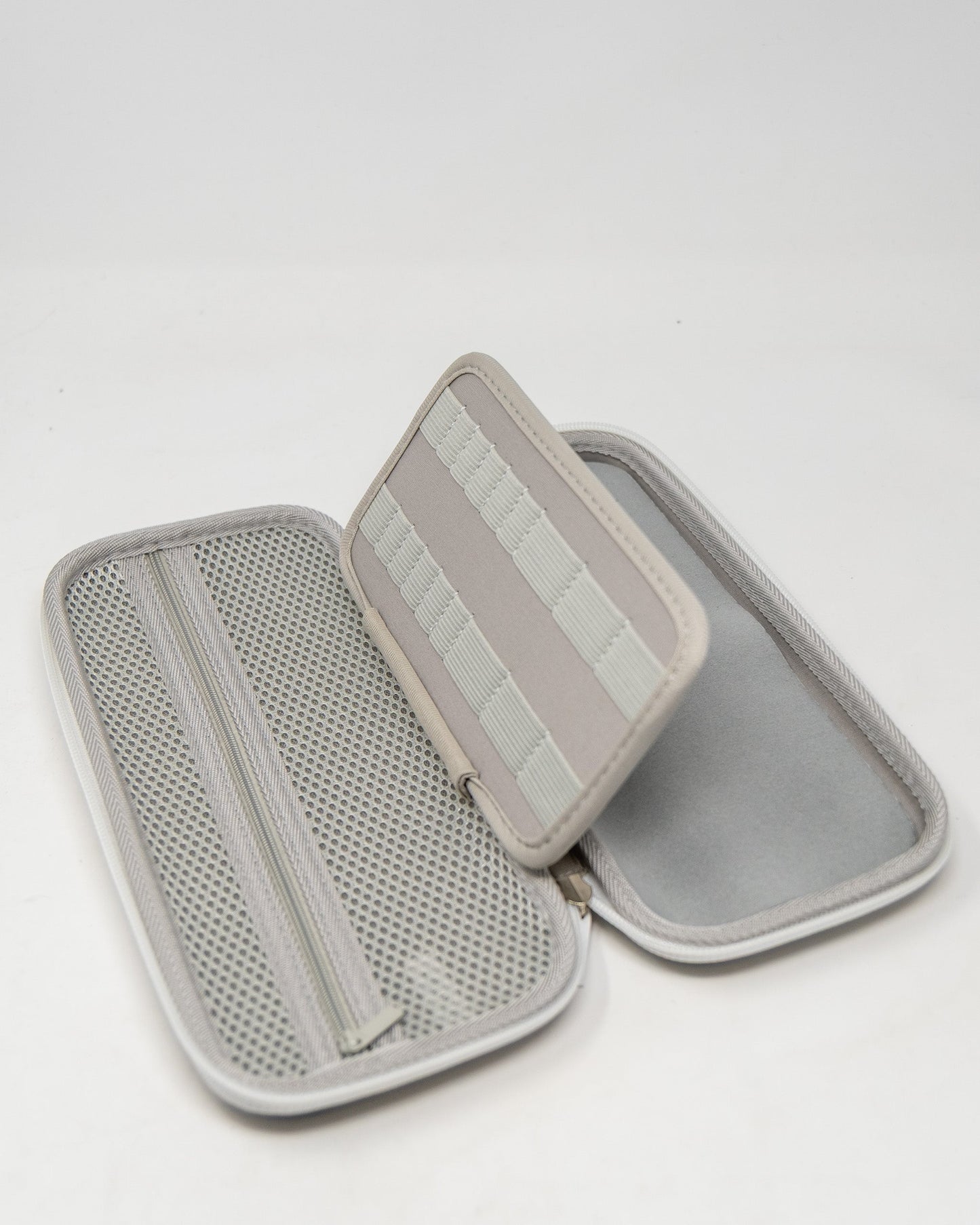 Gray glove and accessory caddie with a zippered compartment and elastic straps for organization.