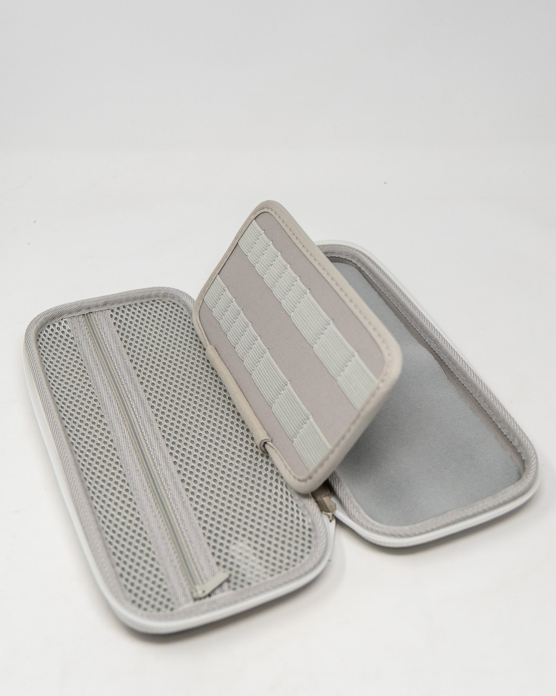 Gray glove and accessory caddie with a zippered compartment and elastic straps for organization.