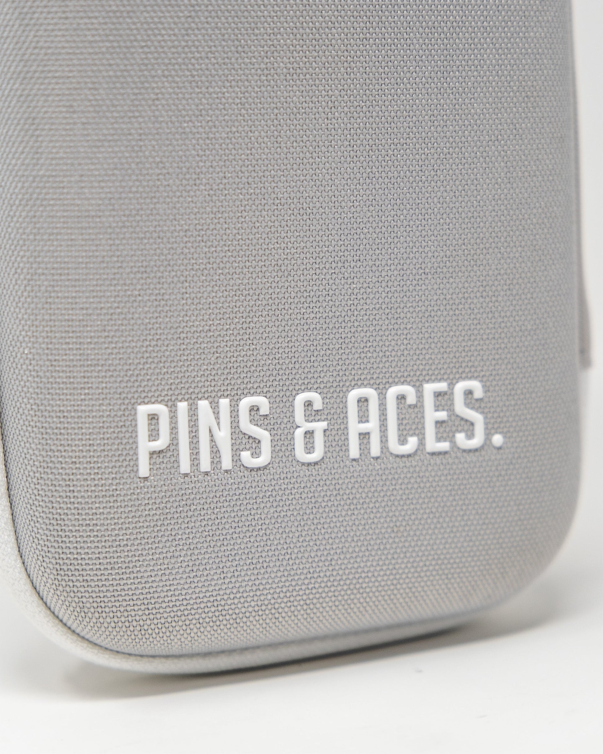 Gray glove and accessory caddie featuring the Pins & Aces logo, designed for organized storage and easy access.