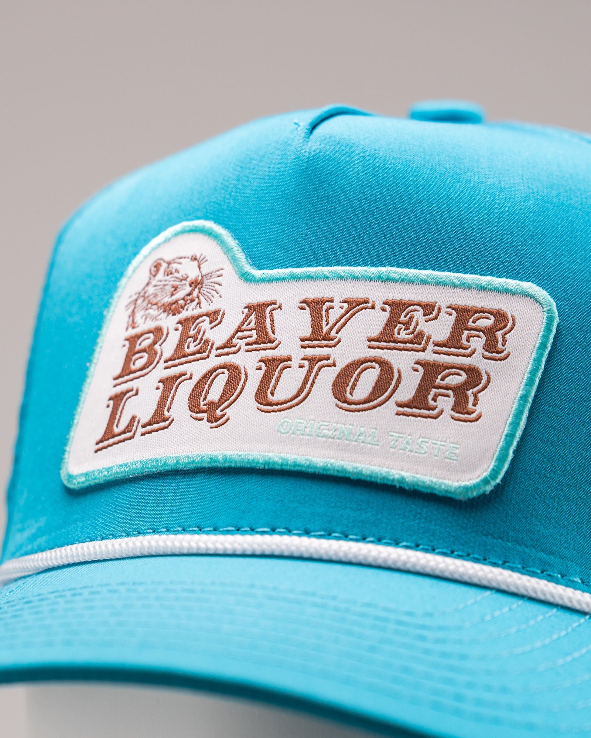 Perforated baby blue rope hat featuring a Beaver Liquor patch.