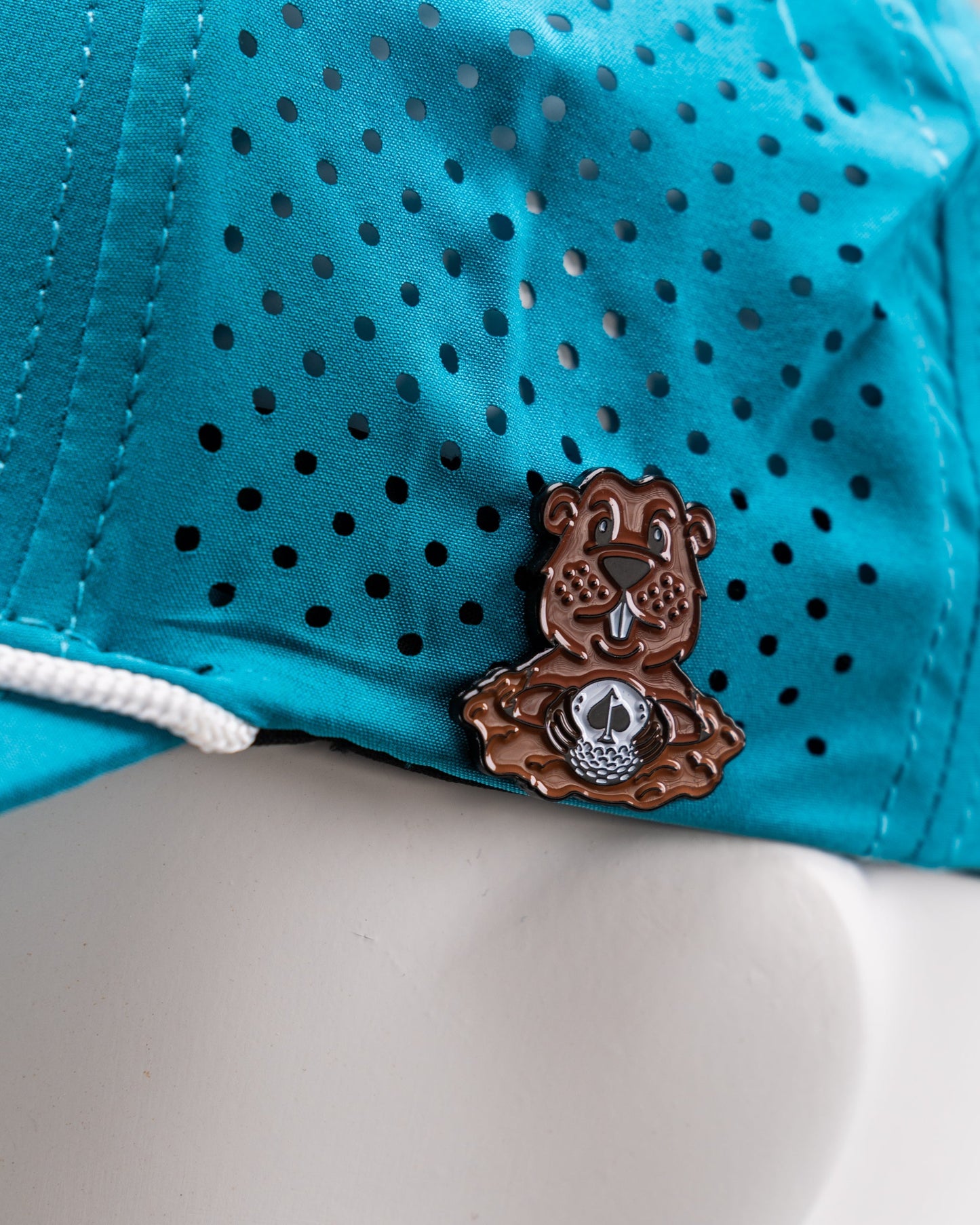Perforated baby blue rope hat featuring a Beaver Liquor logo patch.