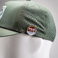 Perforated olive rope hat featuring Zynbabwe Country Club logo on front.