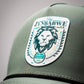 Olive perforated rope hat with Zynbabwe Country Club logo, featuring a snapback closure.