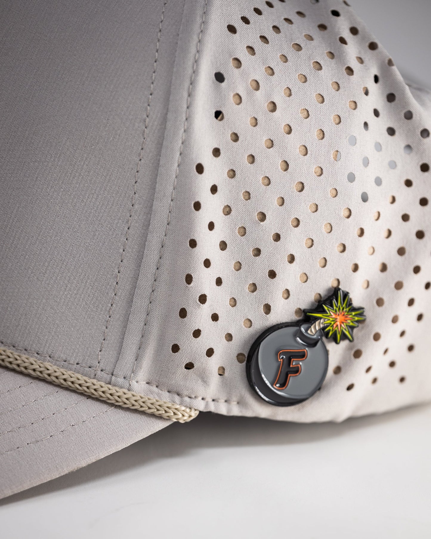 Perforated bone-colored rope hat with a wide brim and adjustable chin strap.