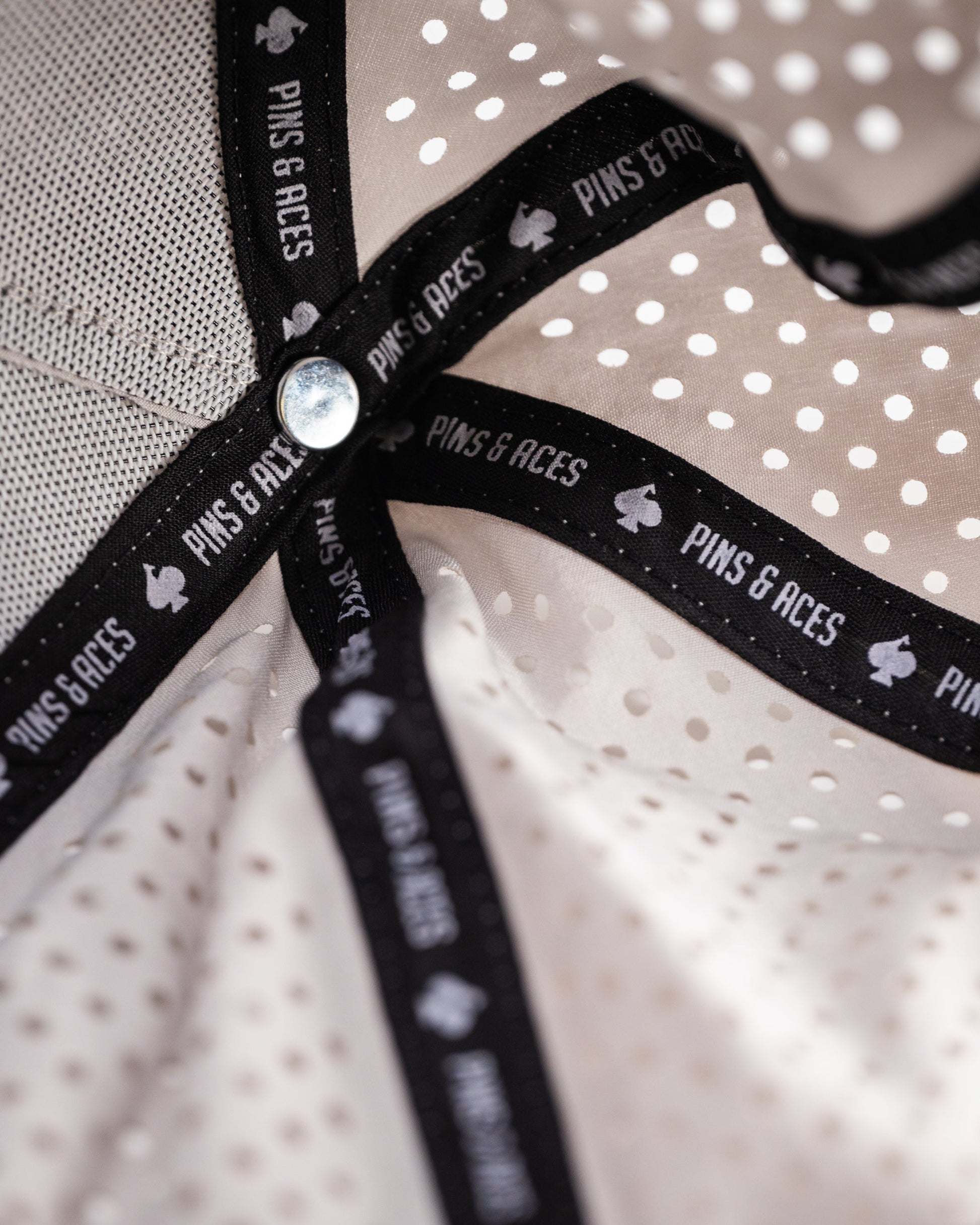 Perforated bone-colored rope hat with a wide brim, featuring a decorative rope band.