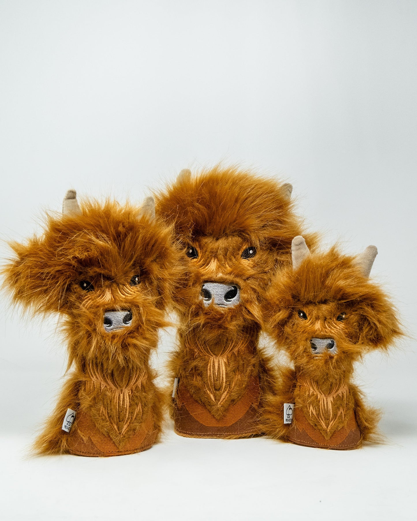 Highland cow driver cover featuring a plush, furry brown cow head with horns, black eyes, and a snout, designed to protect golf club drivers.