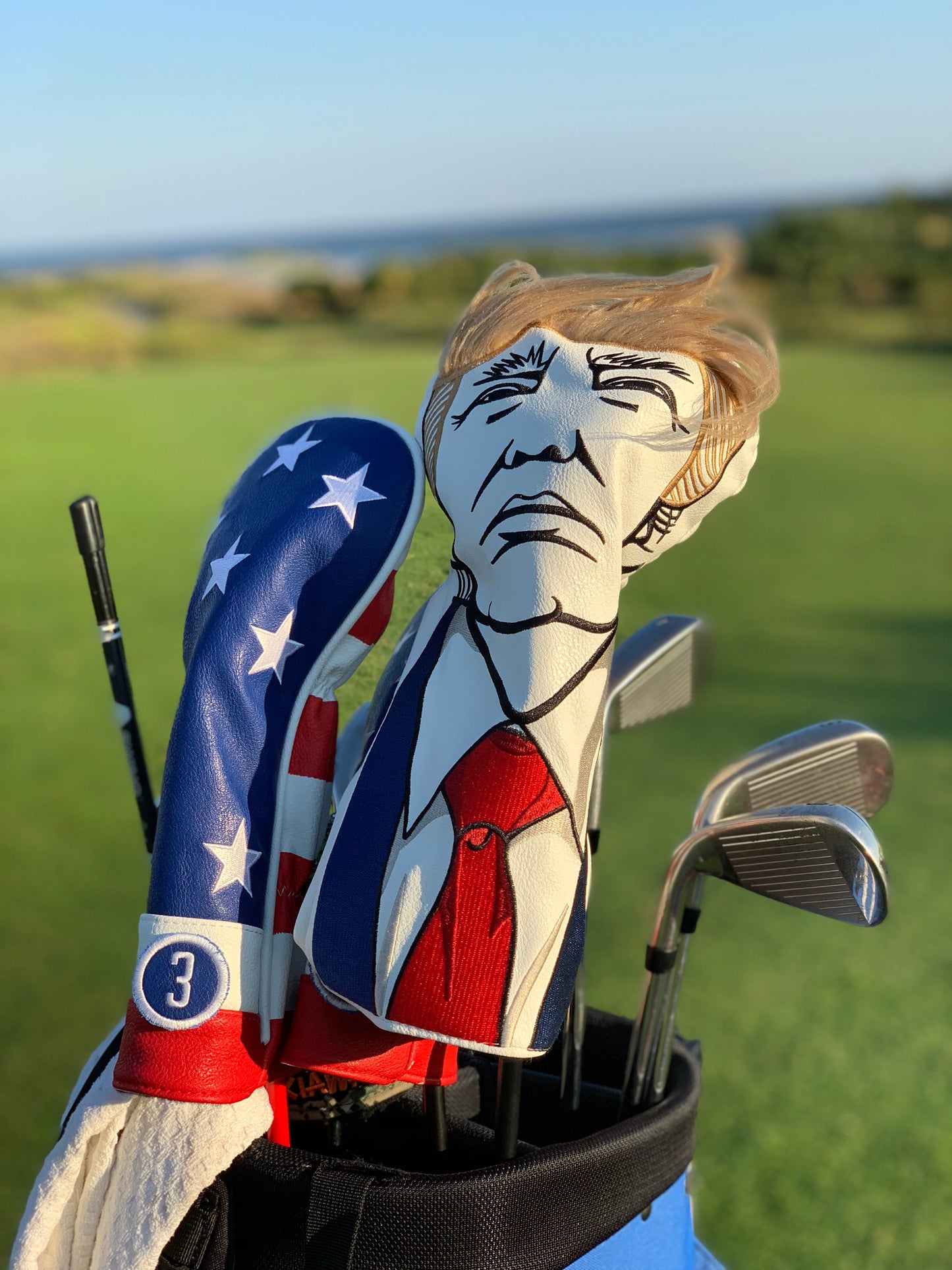 Trump driver cover featuring a patriotic design with bold colors and a prominent "TRUMP" logo. Ideal for golf enthusiasts.
