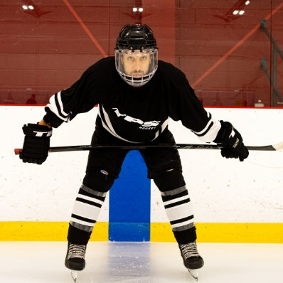 Person in hockey gear on an ice rink
