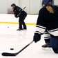 Two ice hockey players on an indoor rink with one player in action.