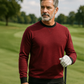 Man wearing a maroon Player Preferred™ Crewneck with black collar, standing outdoors on a golf course.
