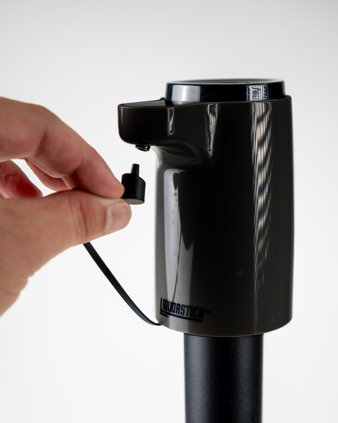 LiquorStick® 3.0 in black, featuring a sleek design and plug for easy use.