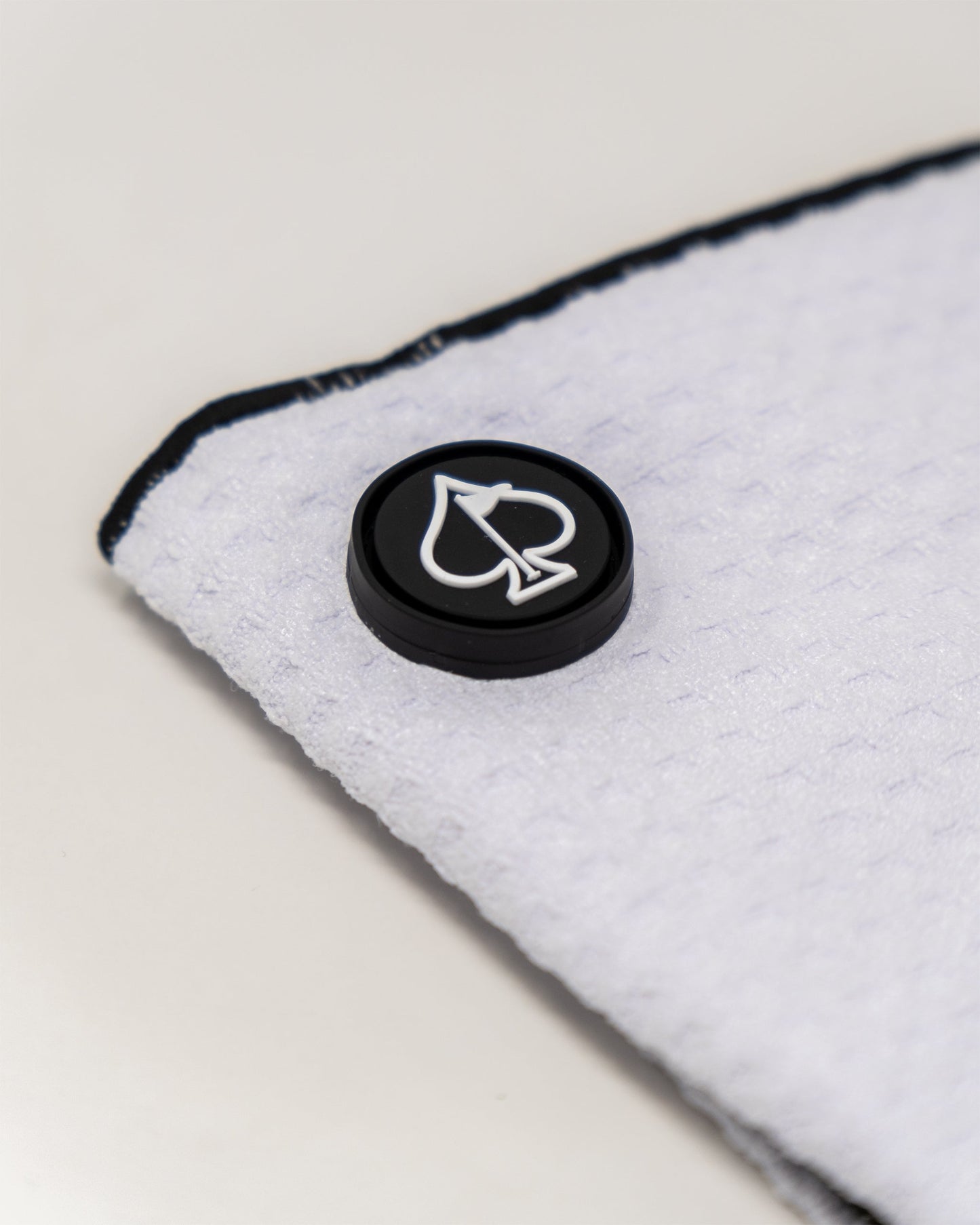 Magnetic white towel showcasing a sleek design with attachment magnets for easy hanging.