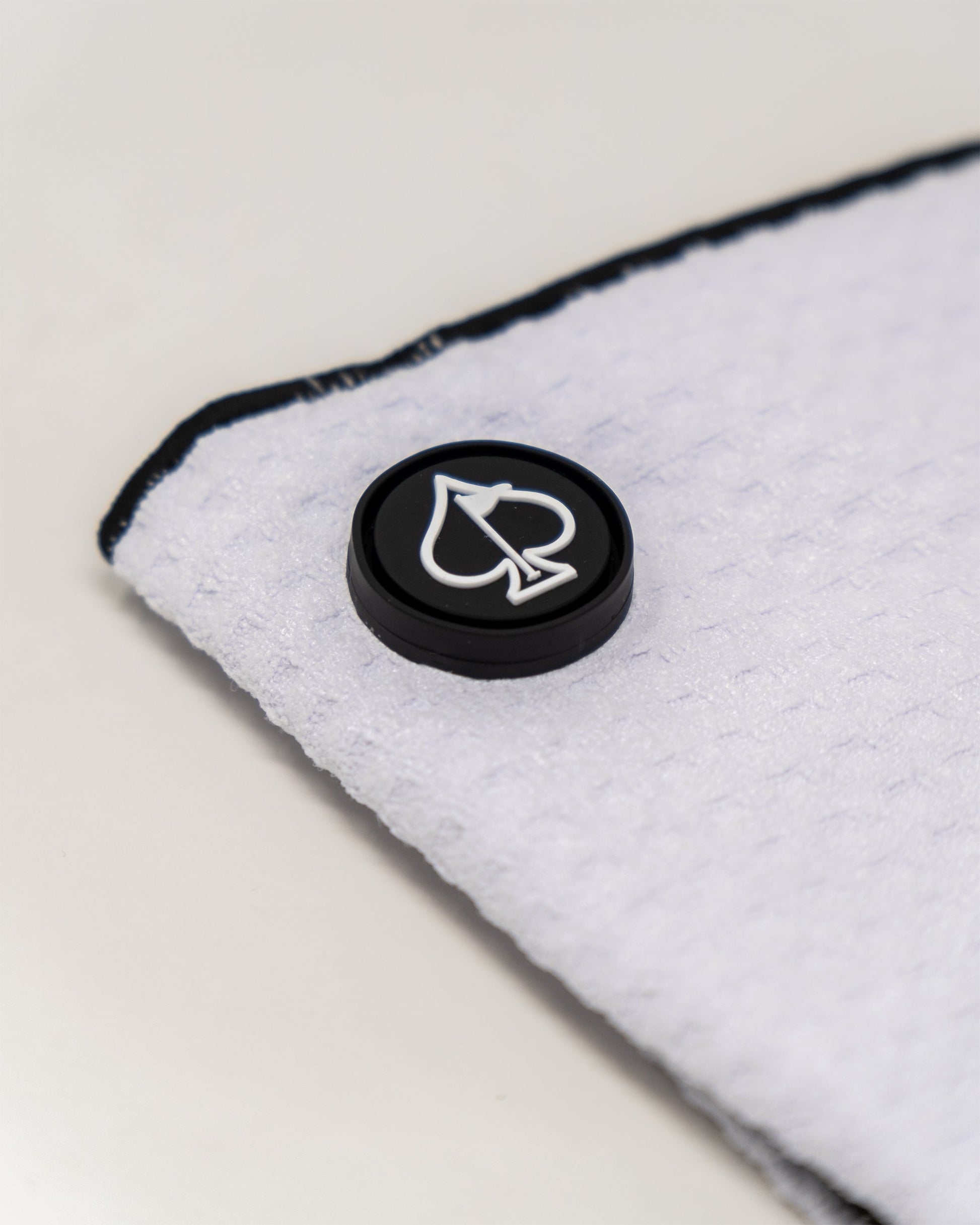 Magnetic white towel showcasing a sleek design with attachment magnets for easy hanging.