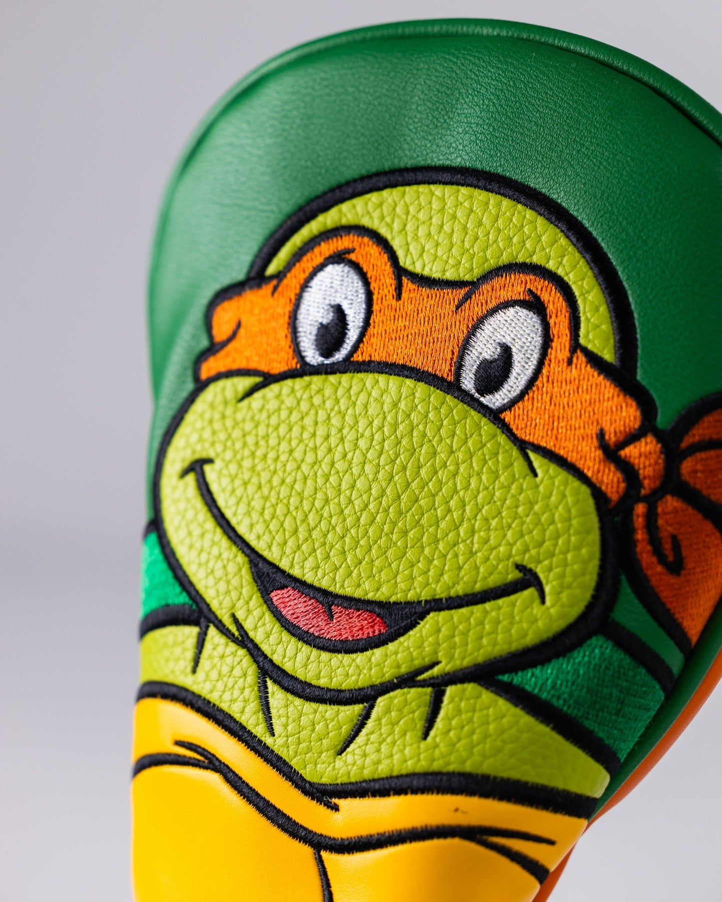 TMNT Michelangelo hybrid golf club cover featuring a vibrant design of the character with a signature orange bandana and nunchaku, ideal for golf enthusiasts and fans.