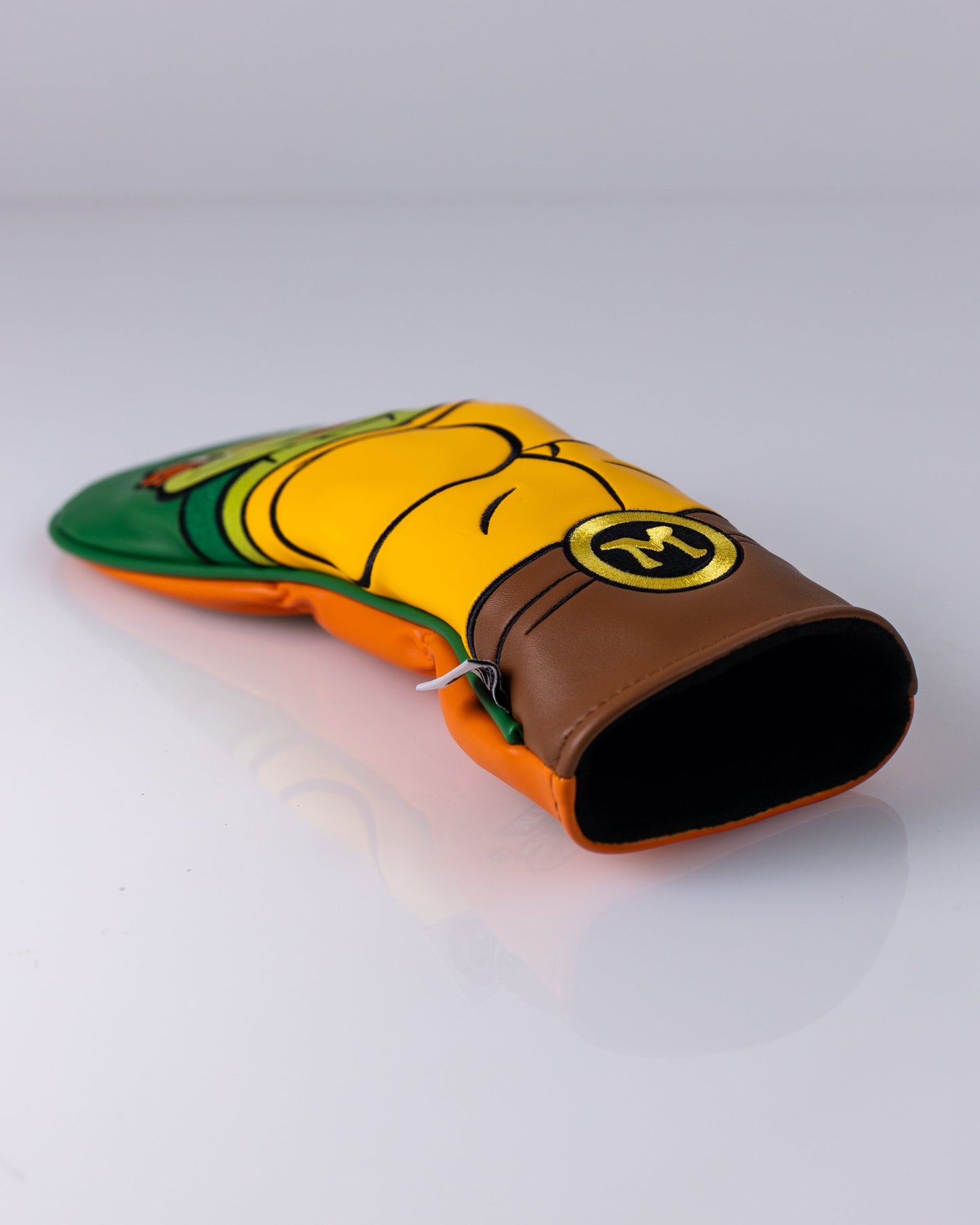 TMNT Michelangelo hybrid golf club cover featuring vibrant orange and green colors with a turtle design.
