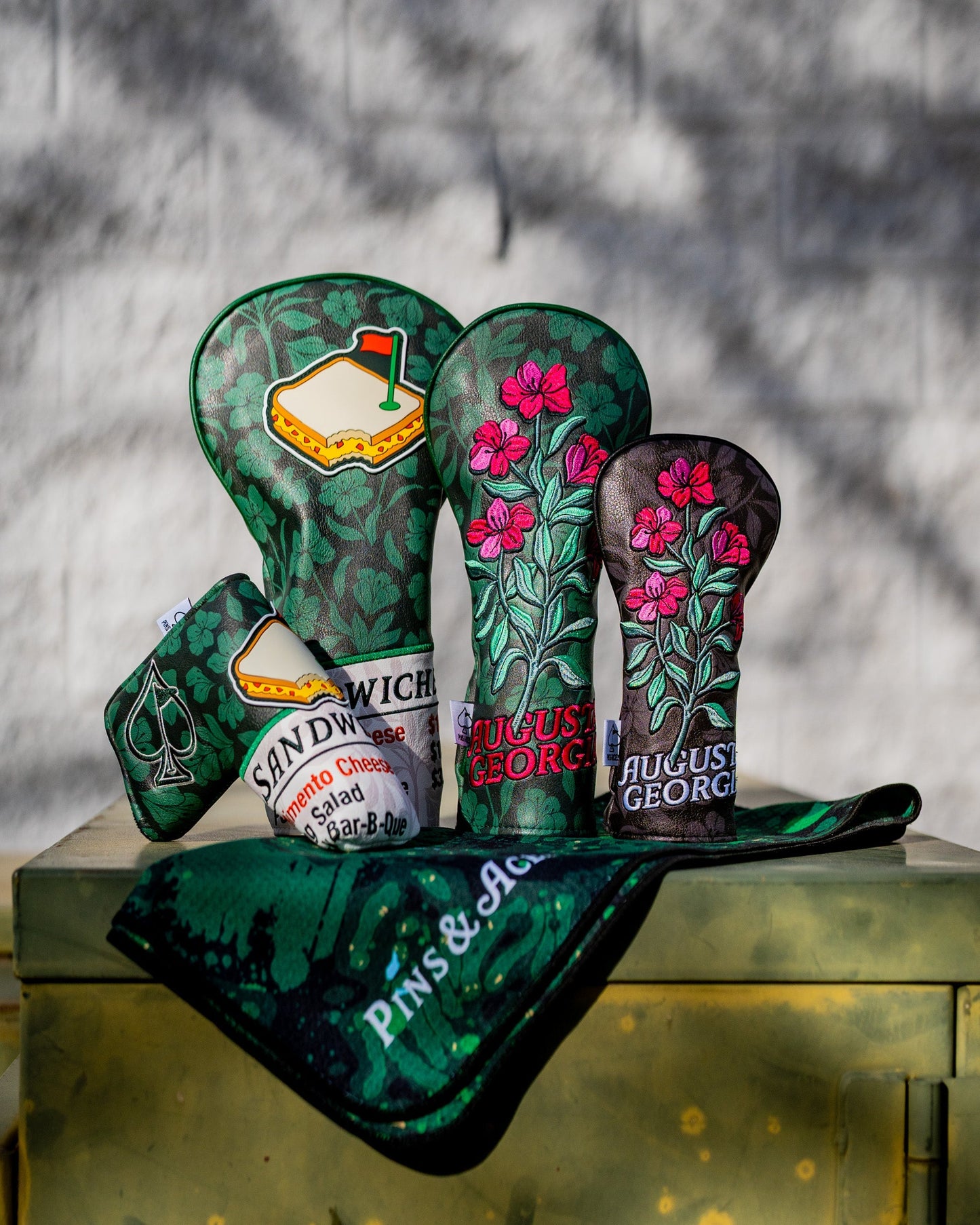 Hibiscus Bloom fairway cover featuring a vibrant floral design in pink and green on a dark background.