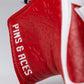 Red golf headcover with textured pattern, white zipper, and "PINS & TACKS" embroidered in white. Perfect for bold golf style.