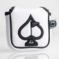 White golf headcover with black spade and flag embroidery, textured background, and "Pins & Aces" logo tag.
