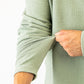 Olive green Player Preferred waffle knit pullover showcasing textured fabric and fitted sleeves for a stylish look.