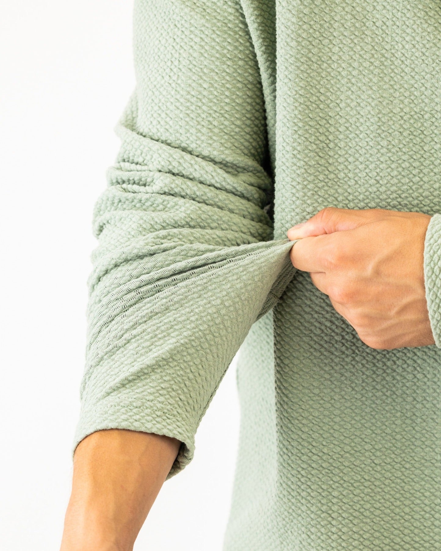 Olive green Player Preferred waffle knit pullover showcasing textured fabric and fitted sleeves for a stylish look.