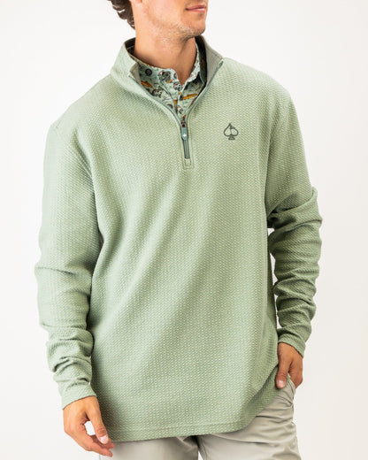 Olive green waffle knit pullover with a quarter zip and logo, perfect for stylish comfort on the golf course.