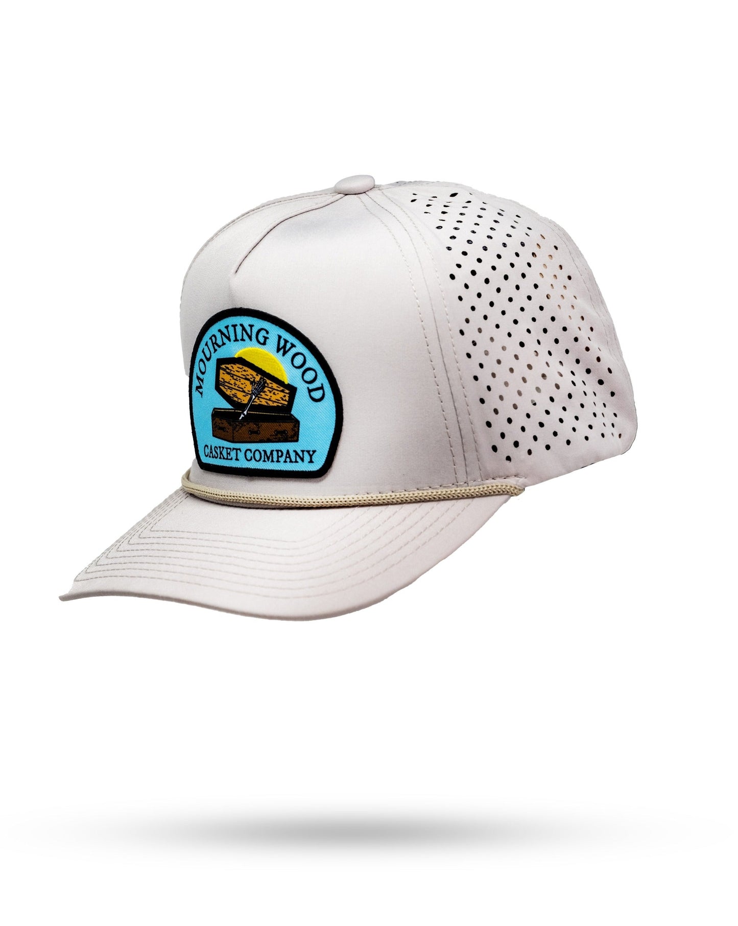 White golf cap with perforated sides, embroidered "Mourning Wood Casket Company" patch, and a curved brim.