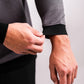 Close-up of a person adjusting the cuff of a slate grey Player Preferred™ Crewneck sweatshirt with black ribbed cuffs.