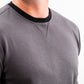 Close-up of a man wearing a slate grey Player Preferred™ crewneck with black collar trim, highlighting the fabric and stitching details.