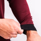 Close-up of a person adjusting the cuff of a maroon Player Preferred™ Crewneck with black trim, highlighting the fabric and fit.