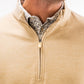 Close-up of a man wearing a sand-colored Player Preferred™ Pullover with a zip front, layered over a patterned button-up shirt.