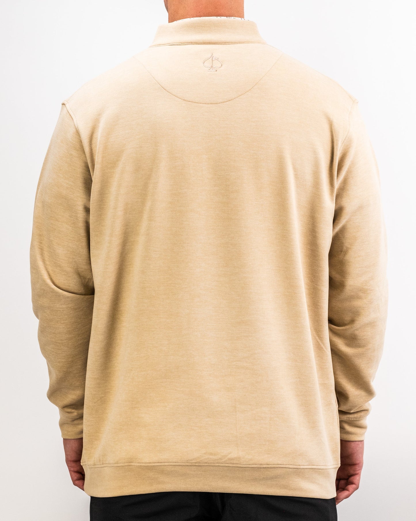 Back view of a person wearing a sand-colored Player Preferred™ Pullover with a subtle embroidered logo on the upper back.
