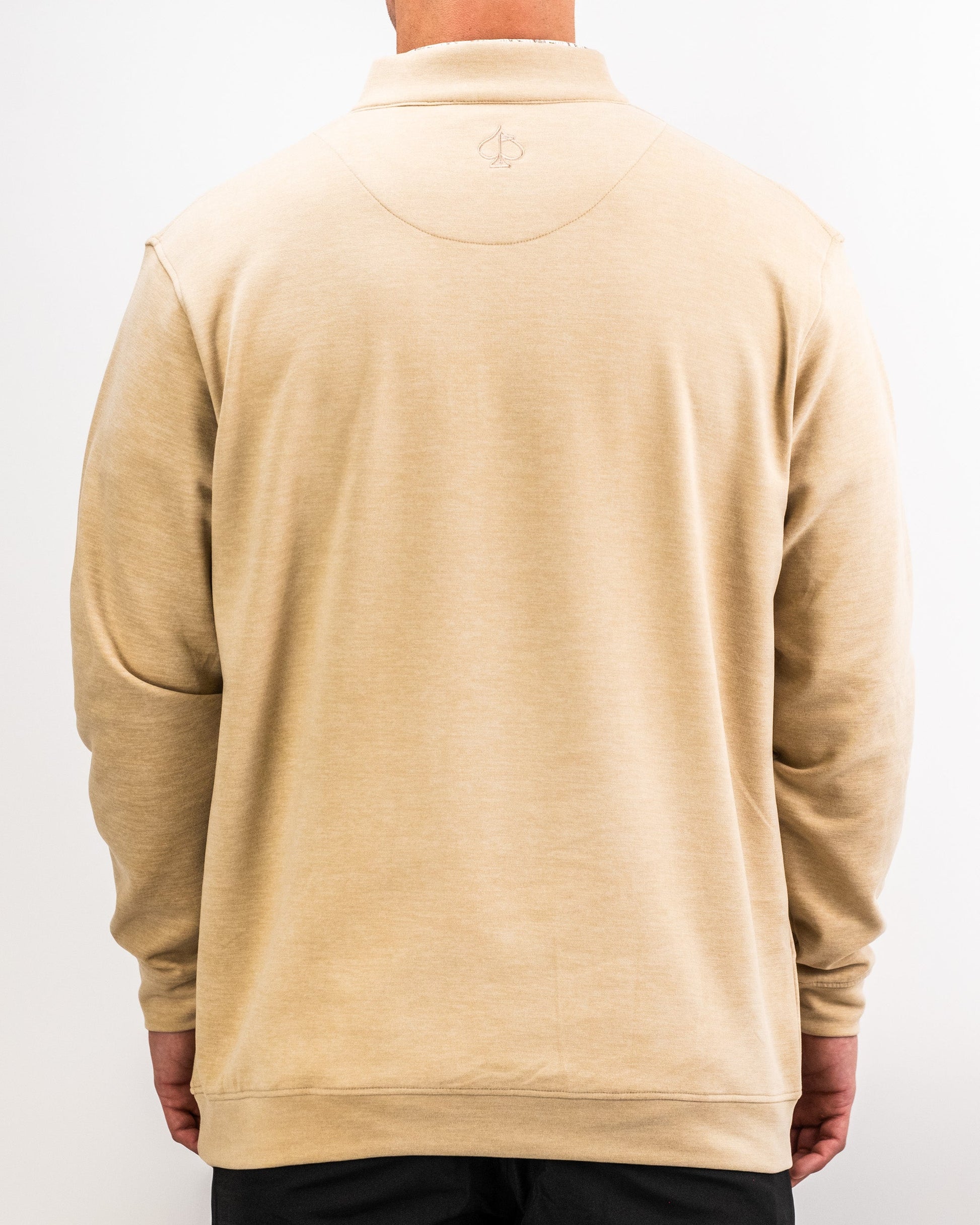 Back view of a person wearing a sand-colored Player Preferred™ Pullover with a subtle embroidered logo on the upper back.