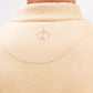 Close-up of the back of a beige Player Preferred™ Pullover with a small embroidered spade logo near the collar.